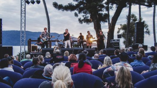 Sunset in the background with Daryl Braithwaite on stage with the band at Daydream Resort 